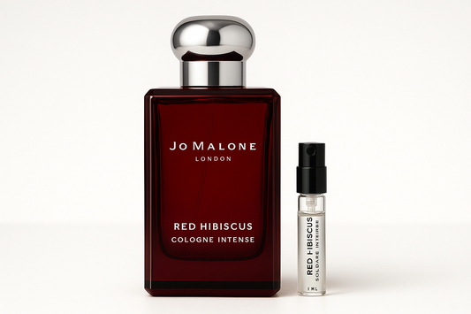 Jo Malone Red Hibiscus Cologne Intense 1 ml campione standing next to 100 ml perfume bottle of Jo Malone Red Hibiscus Cologne Intense which has white writing on dark red bottle