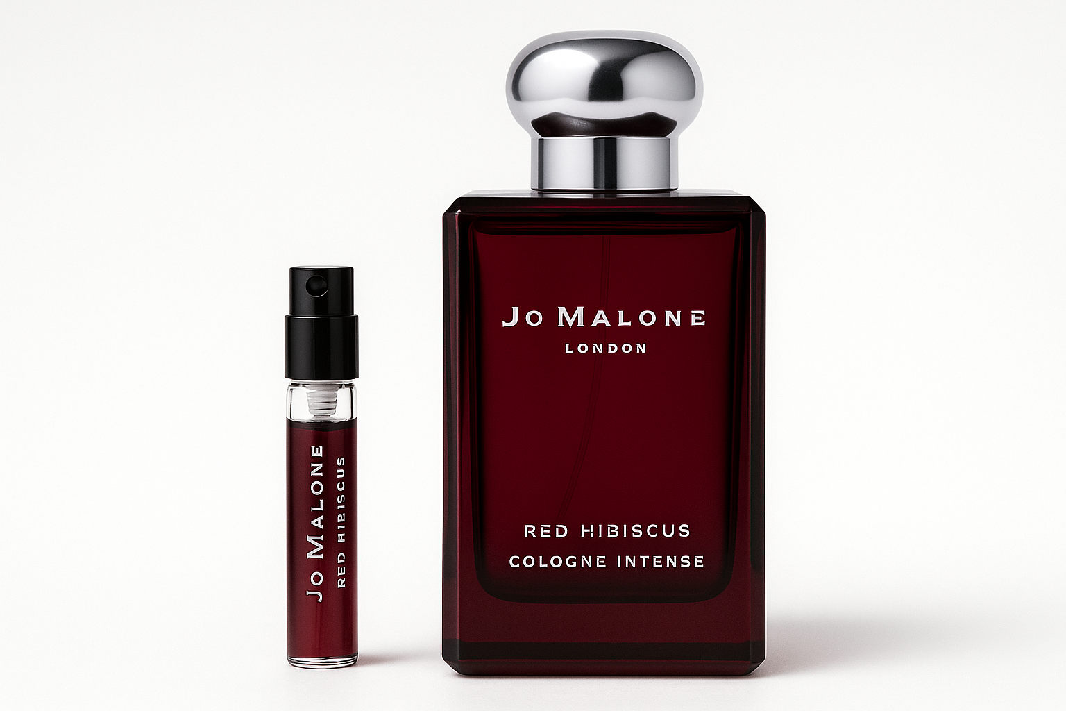 Jo Malone Red Hibiscus Cologne Intense 2 ml campione standing next to 100 ml perfume bottle of Jo Malone Red Hibiscus Cologne Intense which has white writing on dark red bottle